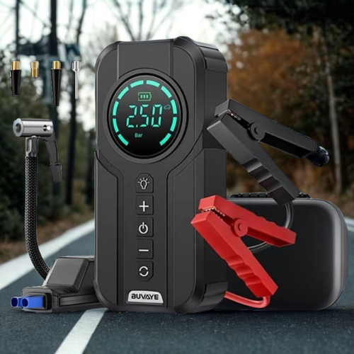 Black portable air compressor with digital display and red clamps on a road background